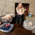 Bailey sitting at the fireplace with her pet dogs