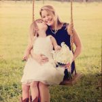 Ellie and Bailey on a swing with white color flowers