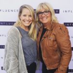 Two women posing for a picture at an influencer program