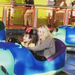 Ellie and her daughter playing dashing car in the fun zone